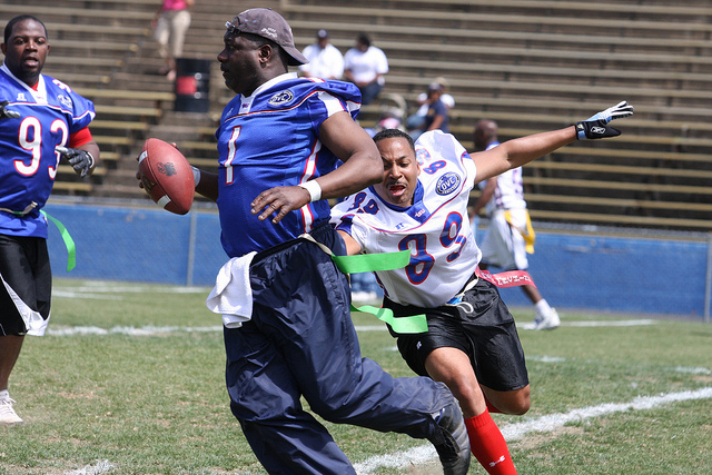 former football players playing flag football