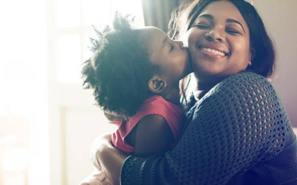 Mother hugging daughter