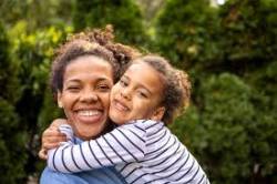 woman holding her child smiling
