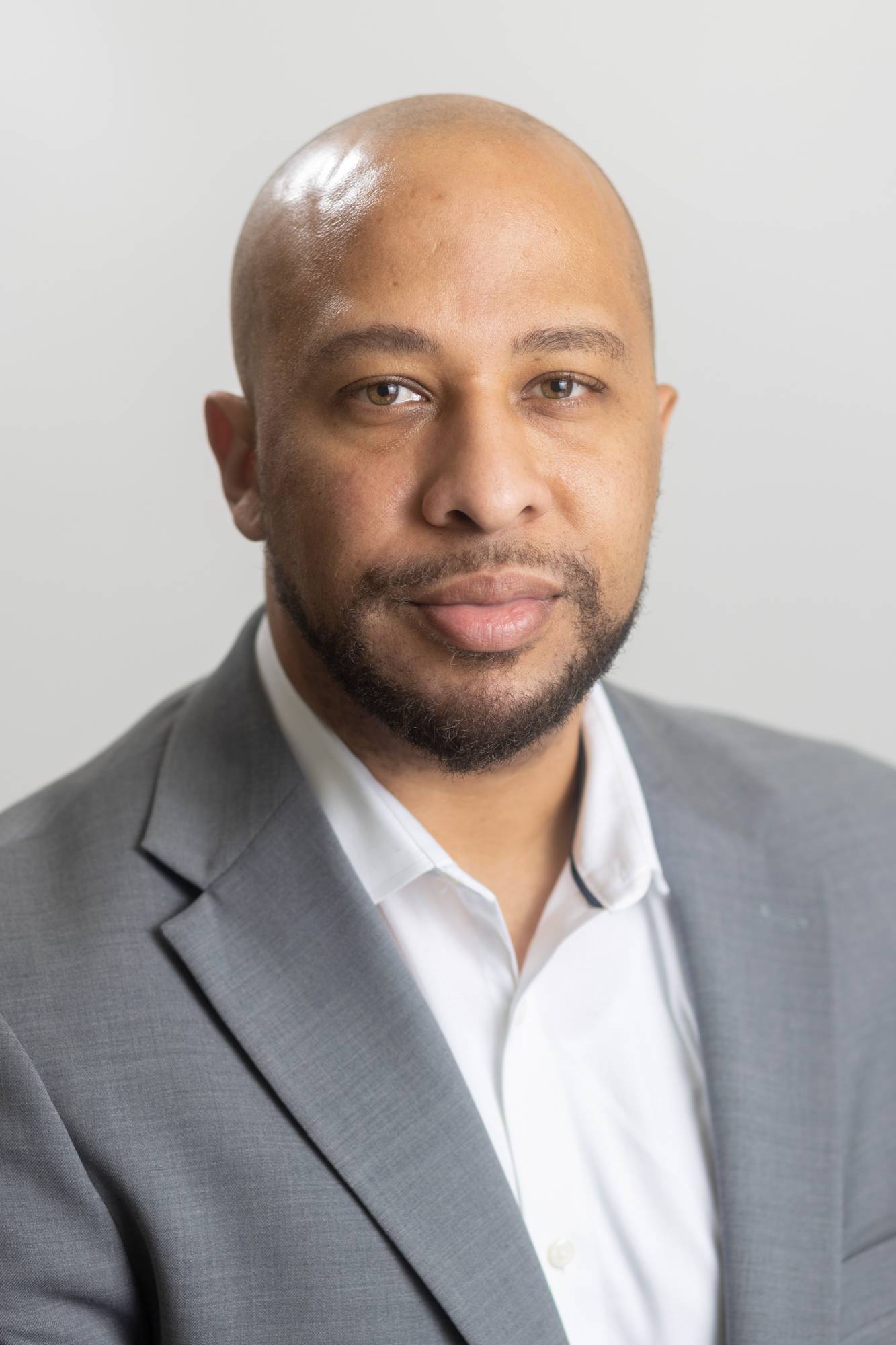 Picture of Assistant Director, Mr. Morrissette smiling.  He is wearing a grey jacket and a white shirt. 