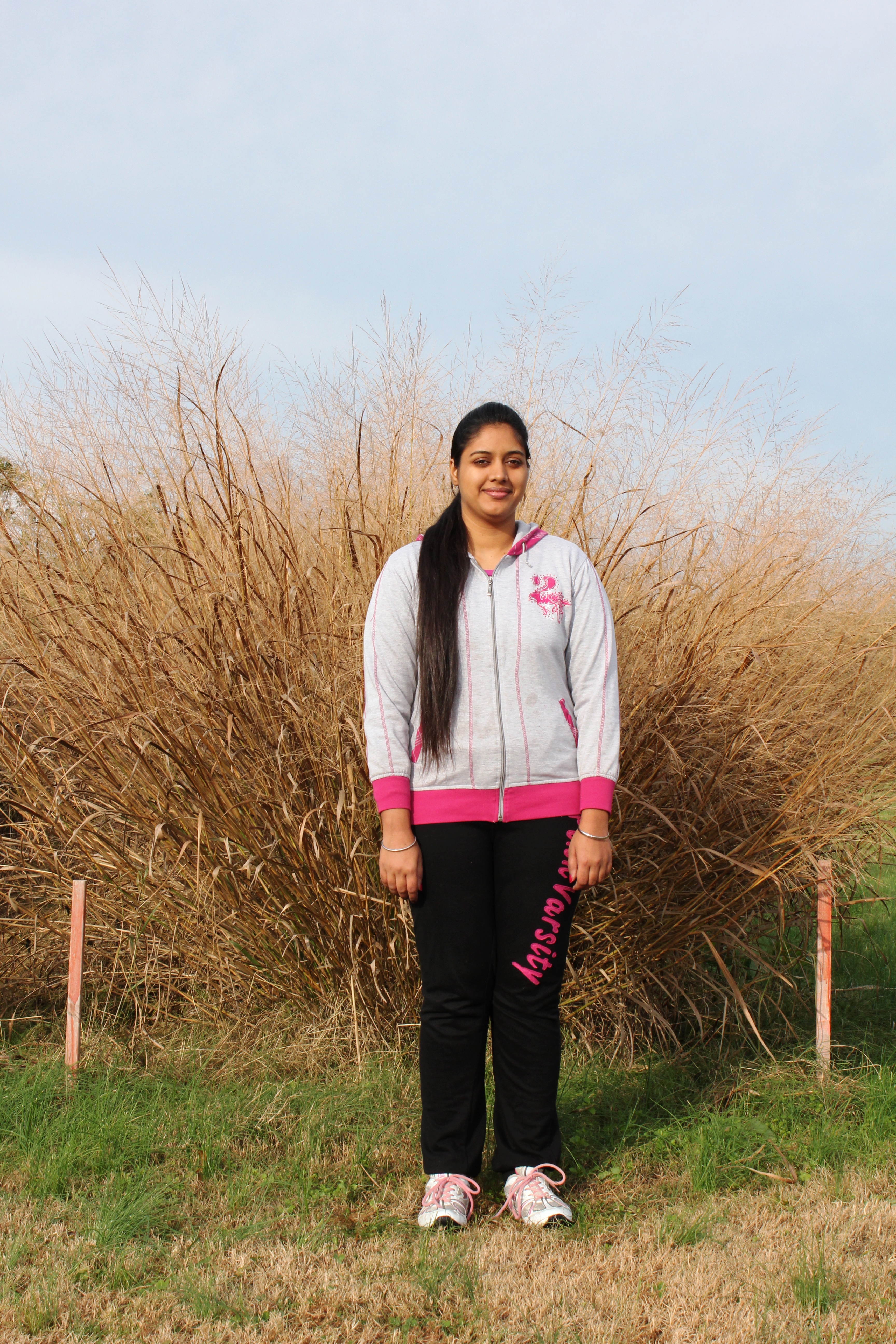 Priya Saini by the switchgrass plots.