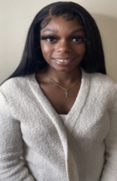 woman smiling in a white sweater
